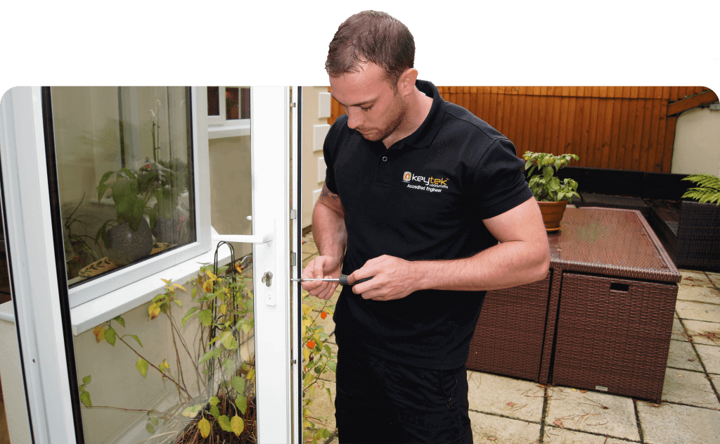 keytek locksmith with tools working on upvc patio door