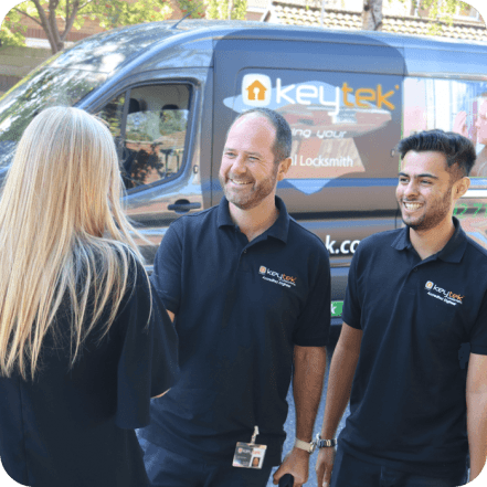 two keyetk locksmith shake hands with a customer with keytek van in the background